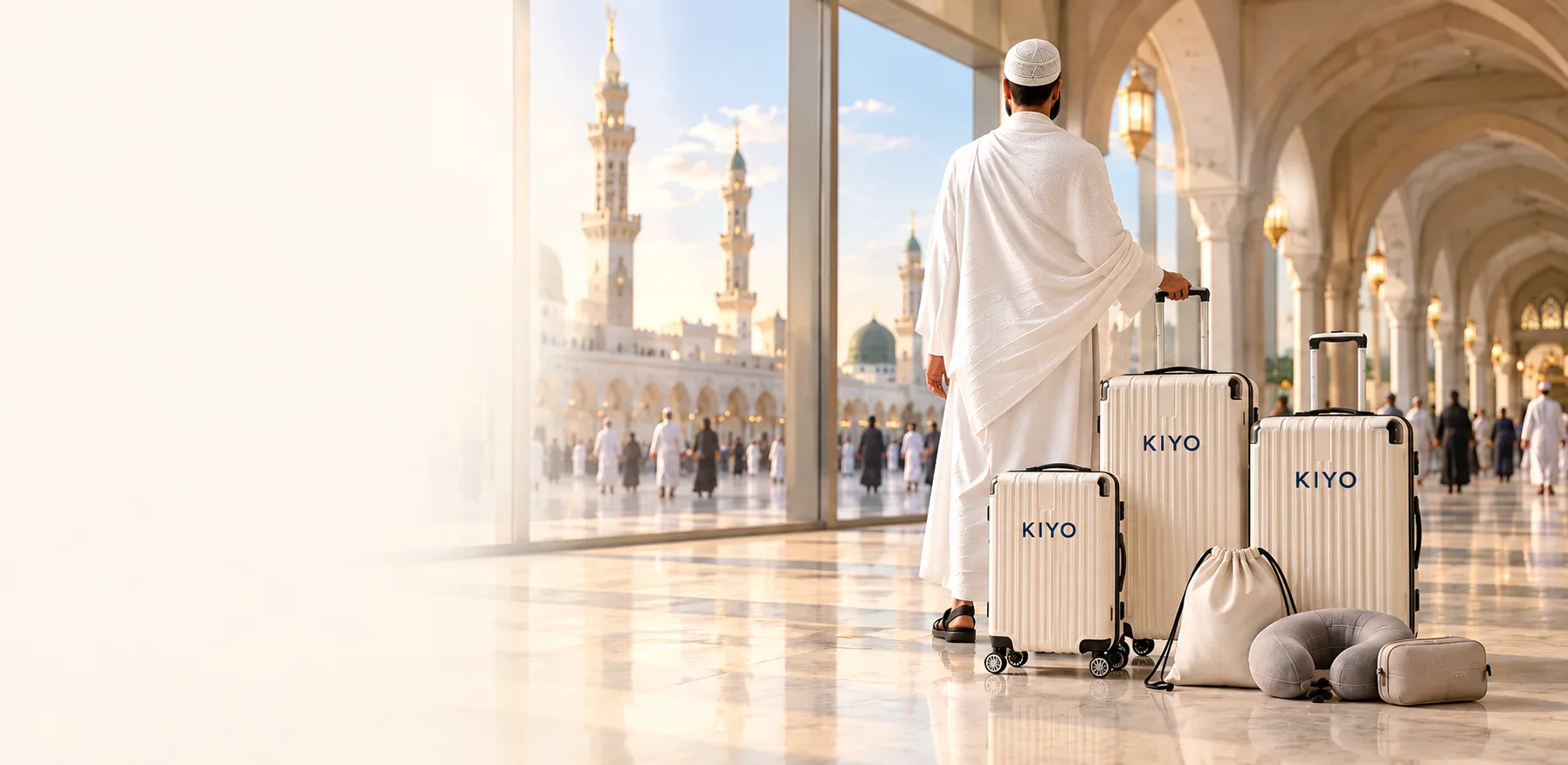 A pilgrim in ihram walking towards the mosque with a coordinated cream KIYO luggage set